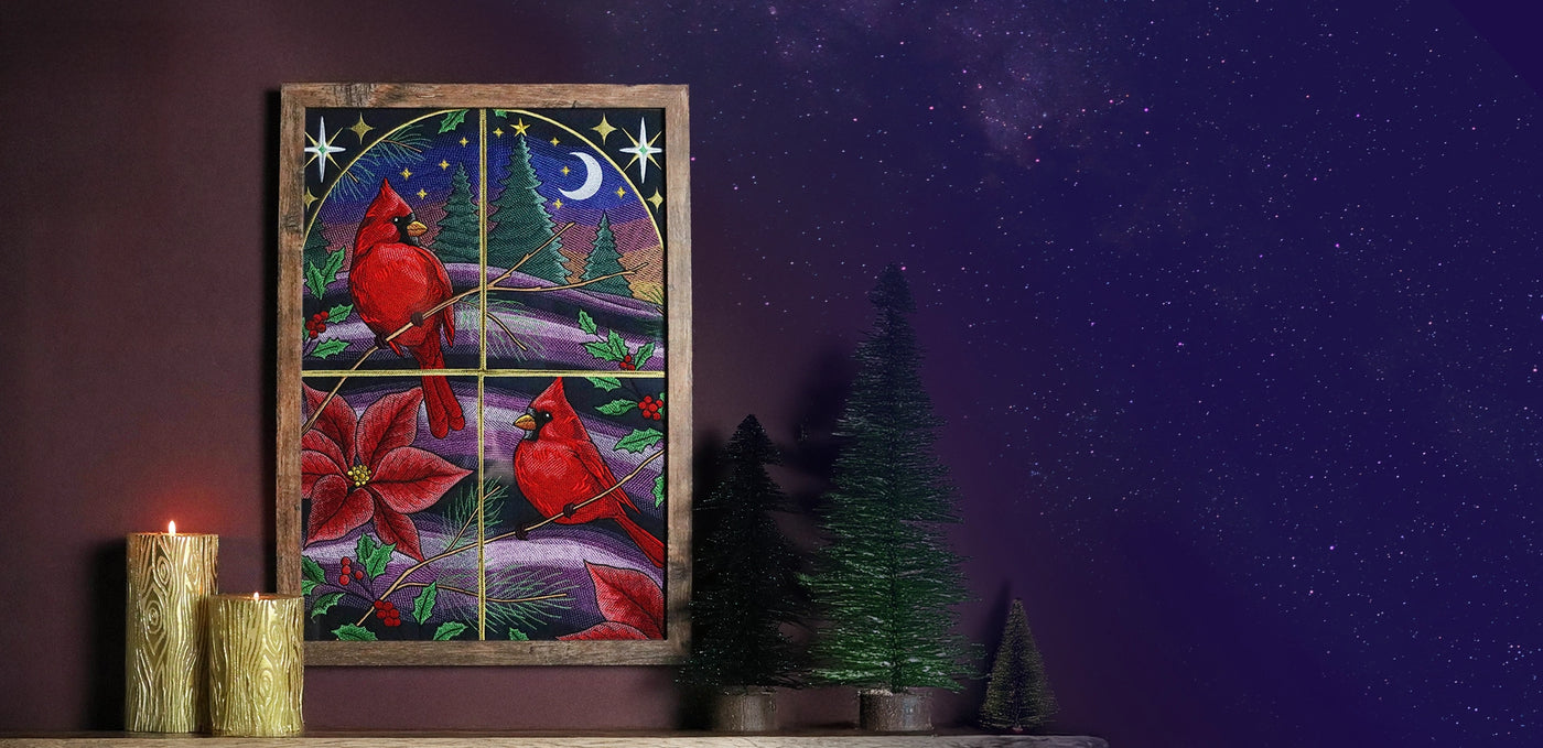 Decorative machine embroidered window scene with cardinals and poinsettias on a dark background