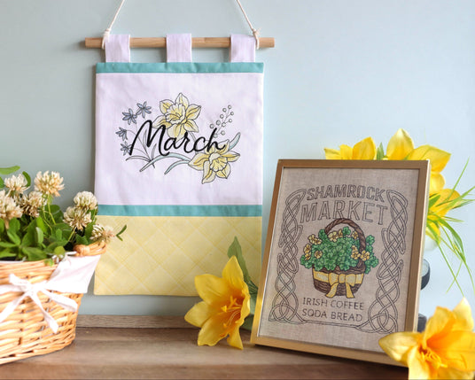 Machine embroidery March-inspired designs on wall hanging and framed surrounded by flowers