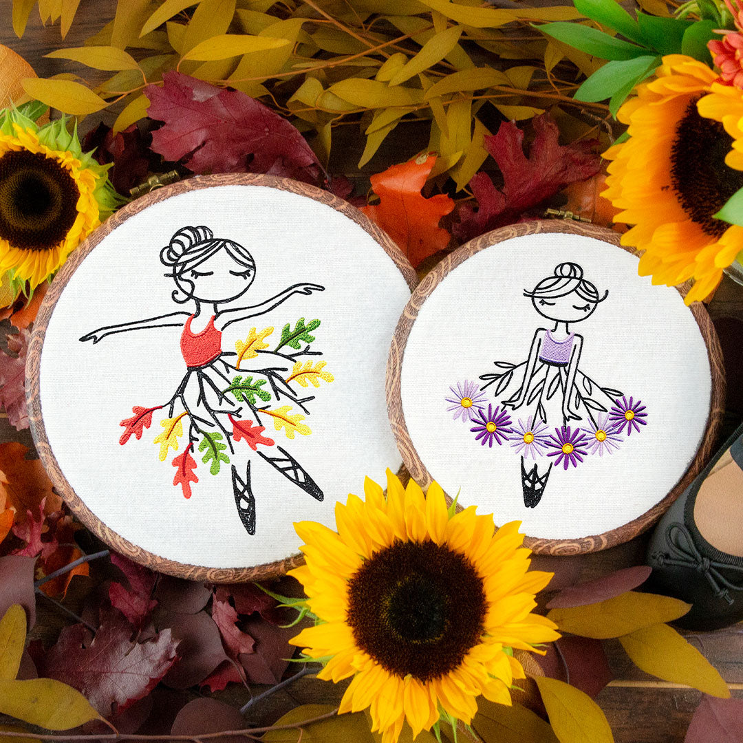 Two embroidered hoops featuring ballerinas with leaf and flower skirts, accented with fall motifs, from a design pack.