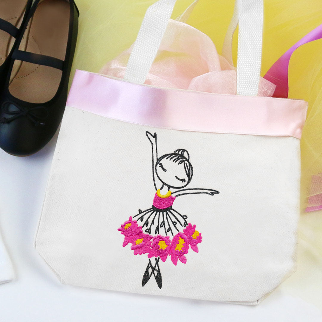 White tote bag featuring machine embroidery of a pink ballerina in classic ballet pose; finished project is shown.