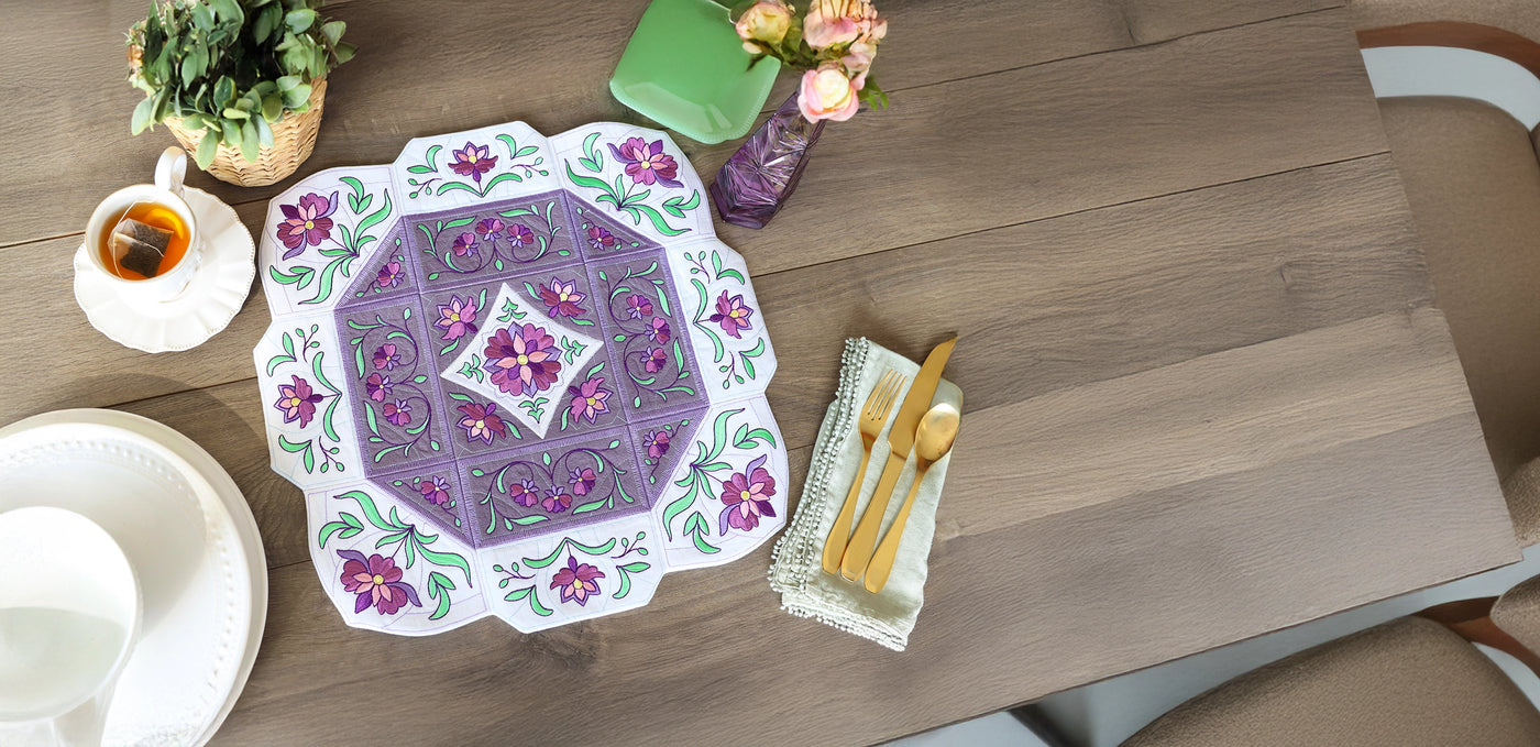 Decorative machine embroidery floral tabletop set on a wooden table.