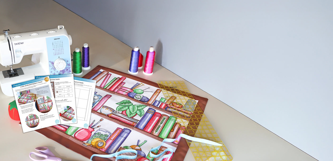 Sewing machine next to a machine embroidery bookshelf design with PDF instructions on top.