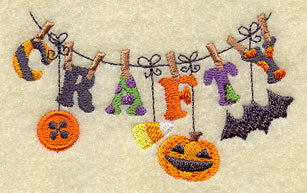 Embroidered CRAFTY letters hang on a line, each decorated with bat, pumpkin, candy corn, and button accents.