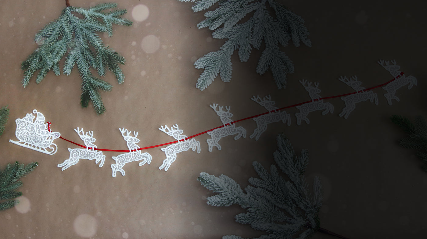 Freestanding lace Santa's sleigh and reindeer machine embroidery designs on a tan background.