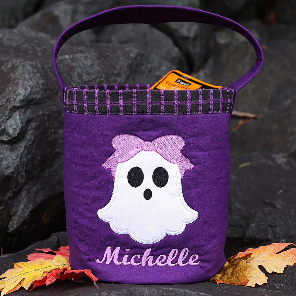 A Halloween bucket tote featuring a ghost machine embroidery design