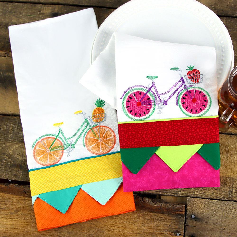 machine embroidery designs of fruit bikes on tea towels with decorative trim