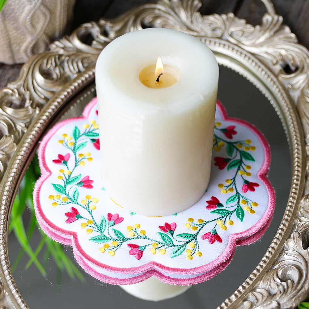 a machine embroidery design of a candle mat