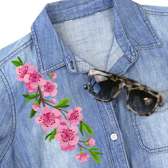 a denim shirt with a floral spray machine embroidery design stitched  on it
