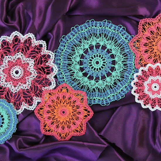 mulit-color machine embroidery lace designs on purple background