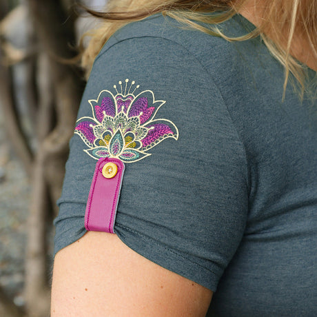 A t-shirt sleeve cinched up with a machine embroidery design of a garment cinch