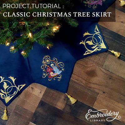 Project Tutorial: Classic Christmas Tree Skirt - a dark blue machine embroidered tree skirt with various designs on the edges - gold tassels - under Christmas tree