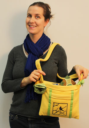 Woman holding completed Embroidered Sweatshirt Tote, featuring Bird's Eye View Silhouette design