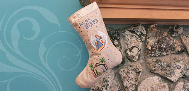 Completed Nativity Stocking project hanging over fireplace