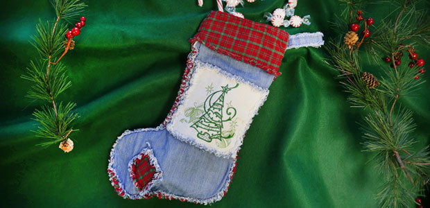 Completed Rag Quilt Christmas Stocking project, with sprigs of holly in the background