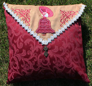 Completed Embroidered Envelope Pillow project, featuring  Light and Lacy Umbrella Girl design