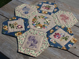 Completed Embroidered Daisy Table Topper project, featuring Sweet Garden Wreath and Flutterby Fancy Flower designs