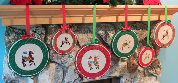 Finished Embroidered hoops featuring Christmas Frolicking Friends Design Packs