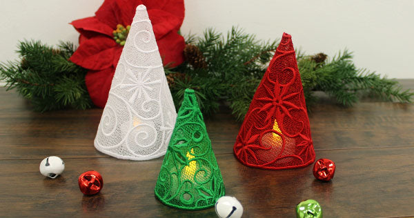 Completed 3D Lace Christmas Trees displayed in white, green, and red