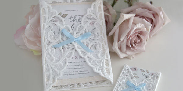 Completed embroidered Freestanding Lace Envelope Sleeve project with roses in background