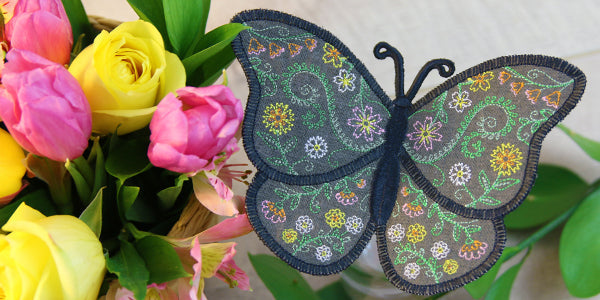 Completed WInged Whimsy Butterfly design pictured with roses