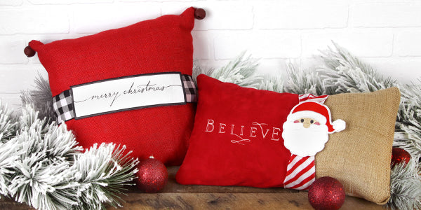 Completed holiday pillow wraps with Christmas decorations