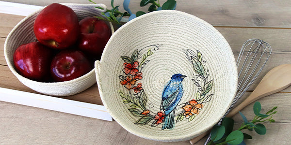 machine embroidery design of a bird stitched onto a rope bowl