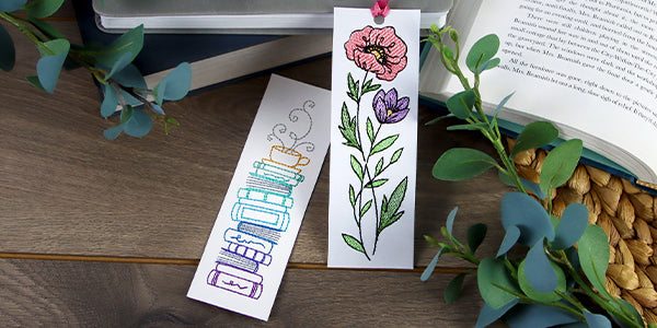 Completed embroidered cardstock bookmark featuring Reading Stack design