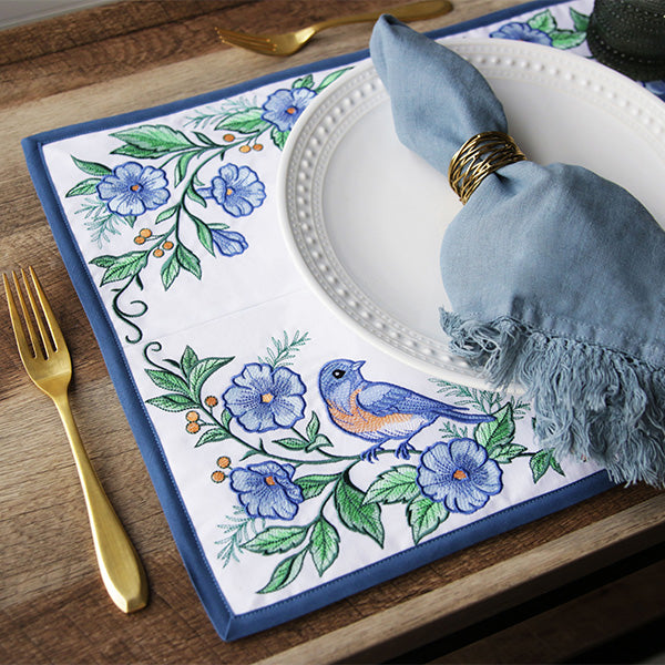 placemat created with four panels of machine embroidery designs featuring a bluebird and flowers