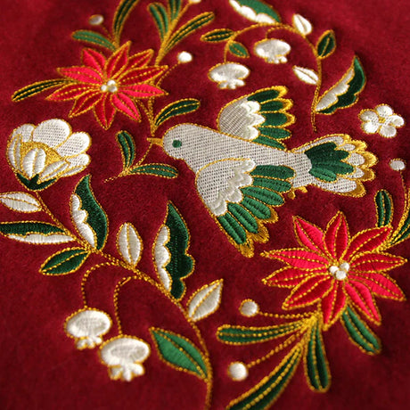 machine embroidery designs of a Christmas bird and flowers