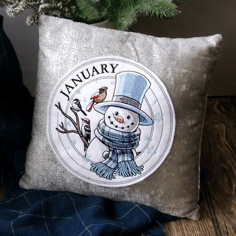January machine embroidery design of a snowman with winter birds