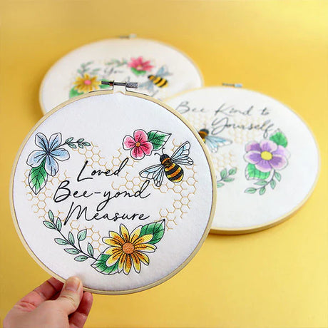 bee machine embroidery designs shown in hand embroidery hoops