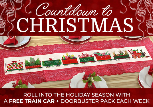 Machine embroidered Christmas train on table runner with text 'Countdown to Christmas roll into the holiday season with a FREE train car + doorbuster pack each week