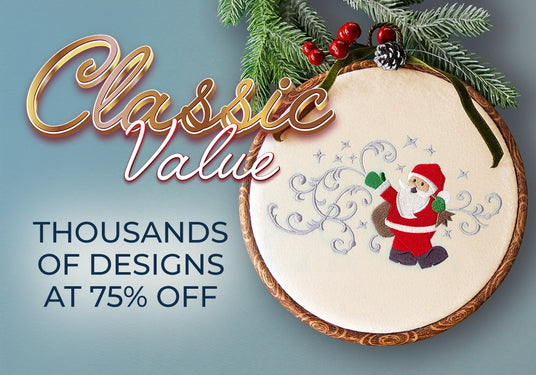 Embroidery hoop with machine embroidered Santa Claus design on a blue background with Christmas decorations.