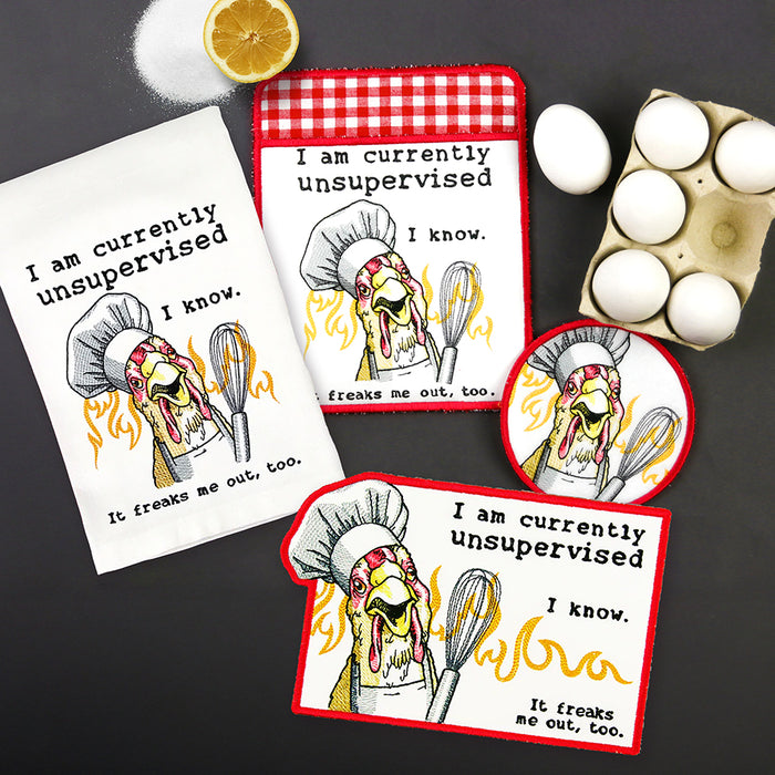 Set of machine embroidered kitchen accessories with a cartoon chicken design and humorous text on a dark surface.