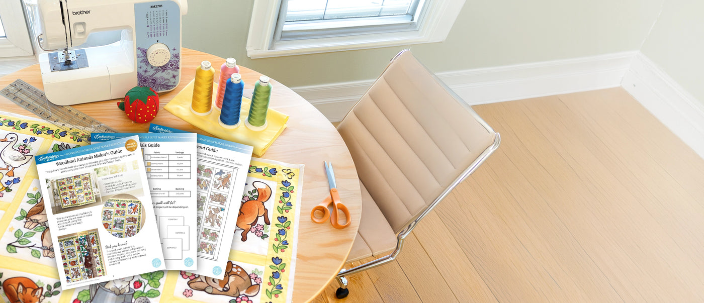 Machine embroidery woodland animal designs on quilt with sewing machine, thread, and a PDF guide.