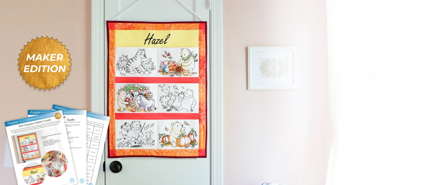 A quilted fabric hanging or poster titled 'Hazel' displayed on a white door in a home interior, with printed booklet pages and a gold 'MAKER EDITION' badge overlaid on the left side.
