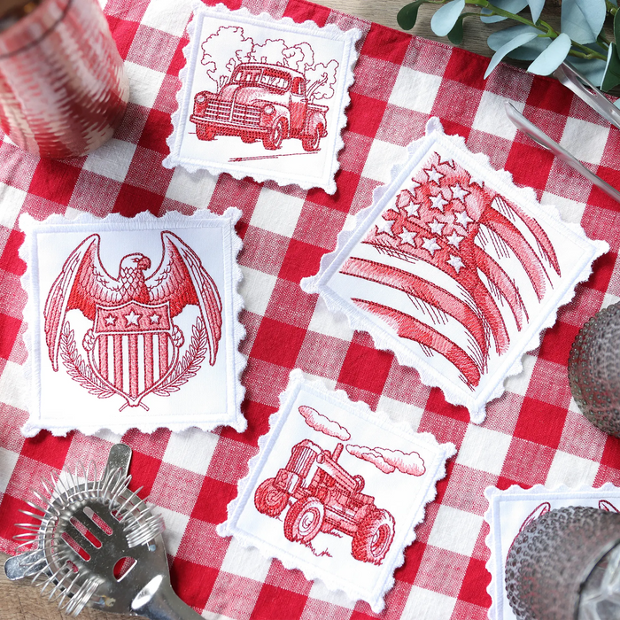 Set of red and white machine embroidered coasters with vintage designs on a red and white checkered tablecloth.