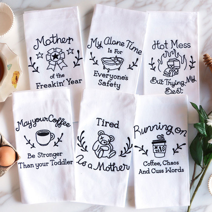 Set of six white towels with machine embroidery sassy mom sayings on a white background.