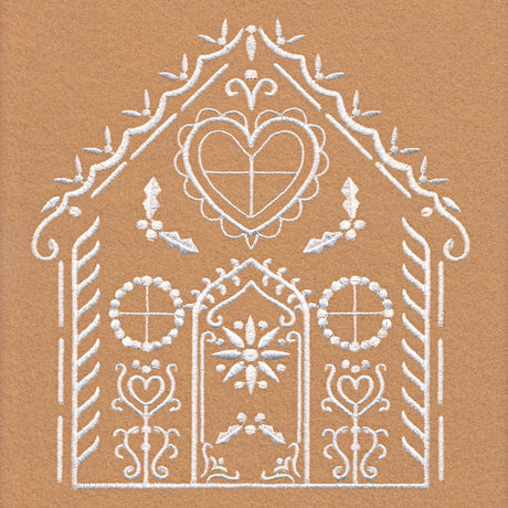 White embroidered symmetrical folk-style house design with heart, floral, and circular window motifs on tan fabric background.