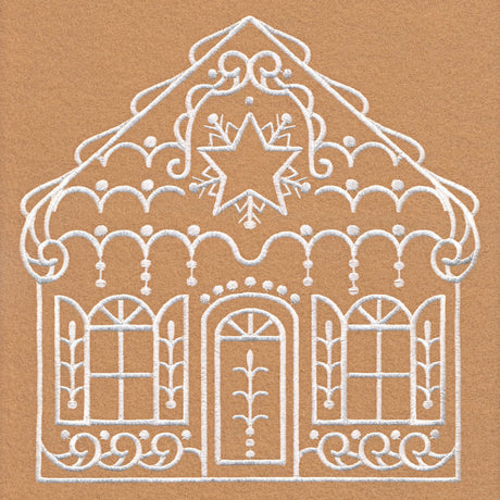 White embroidery on tan fabric depicts a decorative house with a central door, two windows with shutters, scrollwork, arches, and a star with floral motifs at the roof peak.