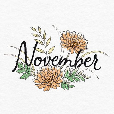 Embroidered word "November" in black script surrounded by orange flowers, green leaves, and yellow foliage on white fabric background.