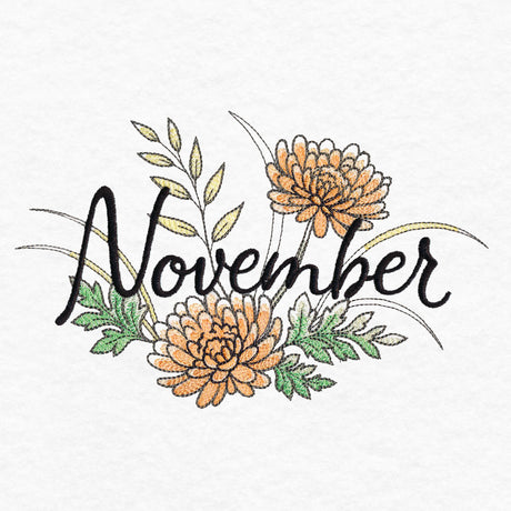 Embroidered design with the word "November" in black script surrounded by orange flowers, green leaves, and yellow accents on white fabric.