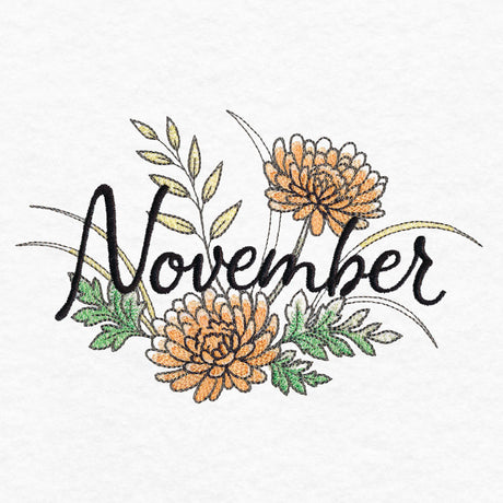 Black script "November" embroidered on white fabric surrounded by orange flowers, green and beige leaves, and brown stems and accents.