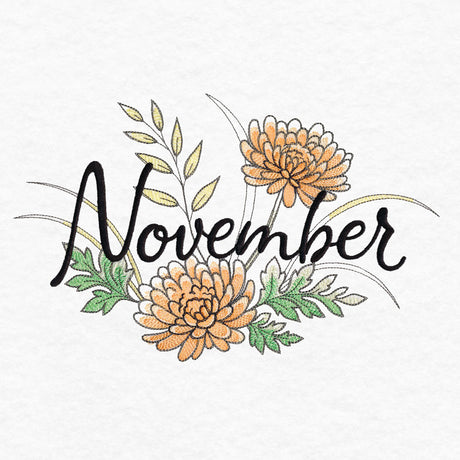 Embroidery of the word "November" in black script surrounded by orange flowers with green and yellow leaves on a white fabric background.