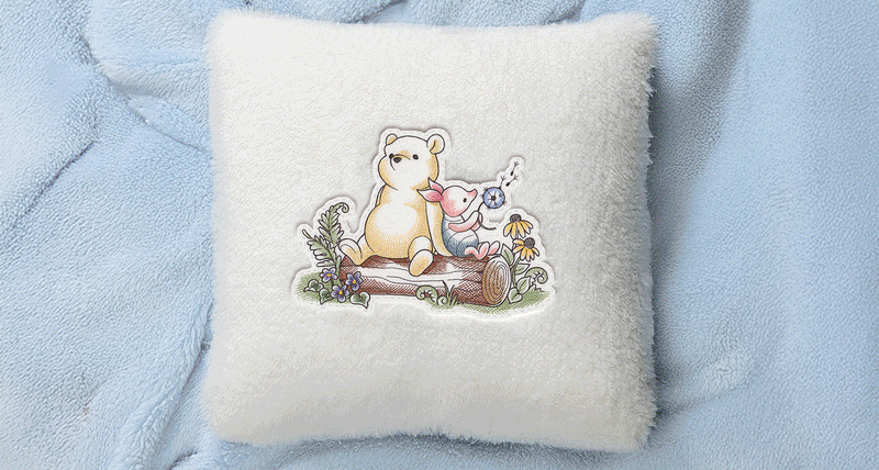 Gif of machine embroidery pooh and friends designs on pillow, bibs, and wall hangings.