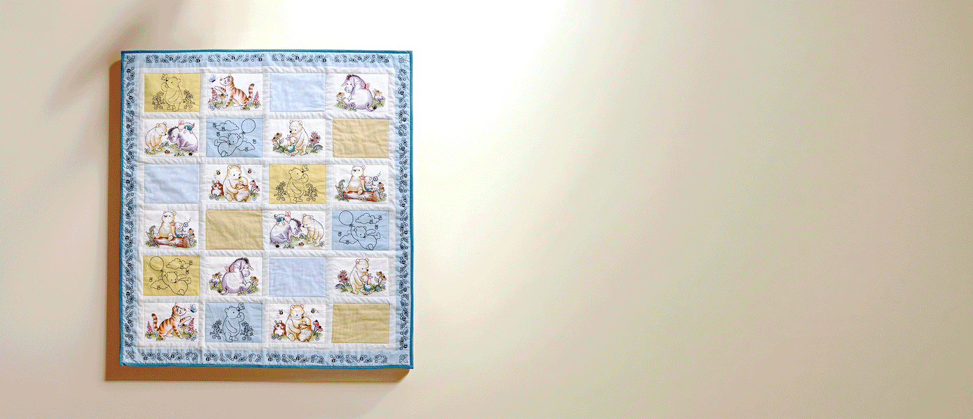Animated GIF of a machine embroidered quilt with the block alternating between various pooh bear and friends designs.