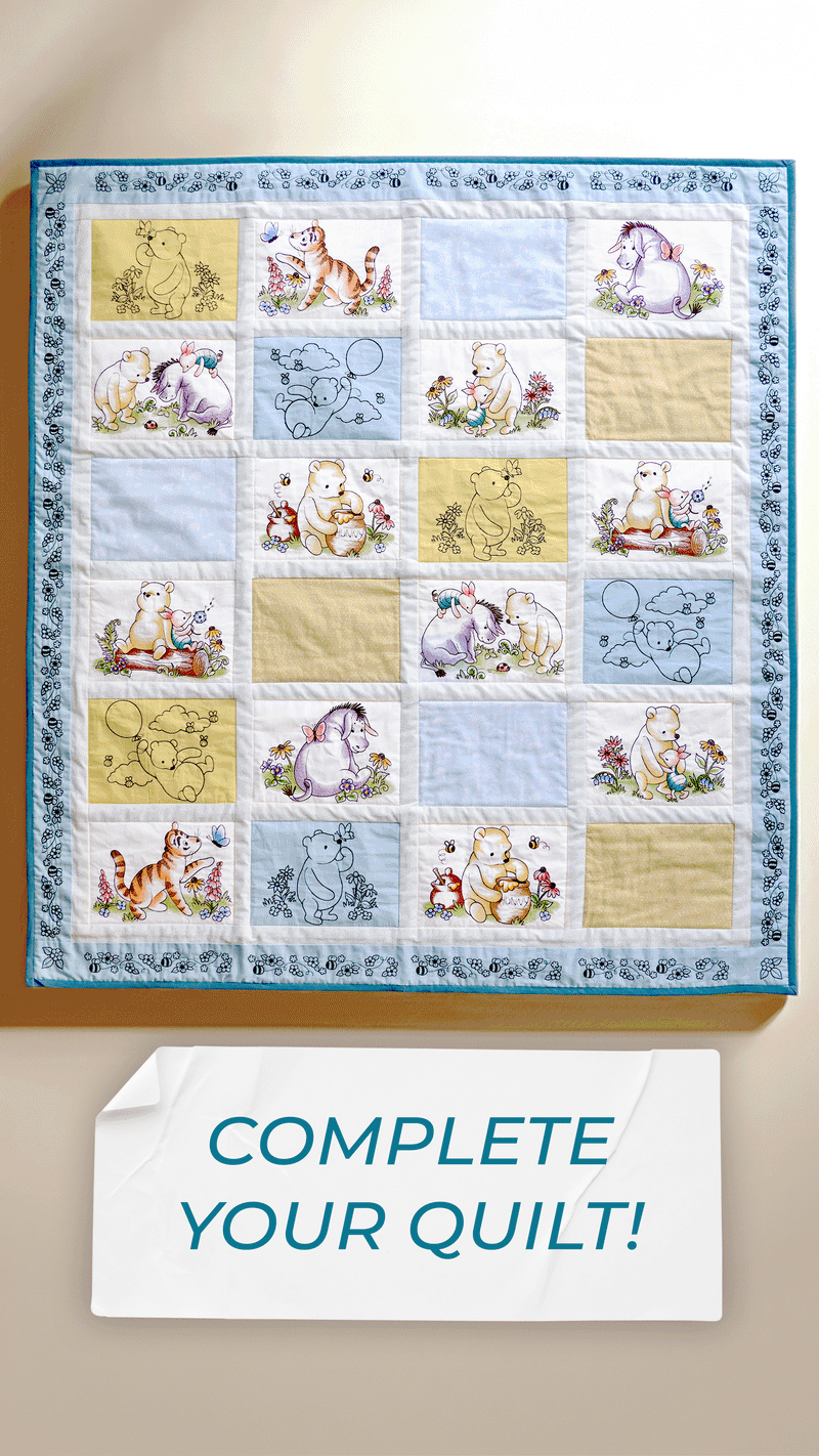 Machine embroidery pooh and friends designs on a quilt with text 'complete your quilt'