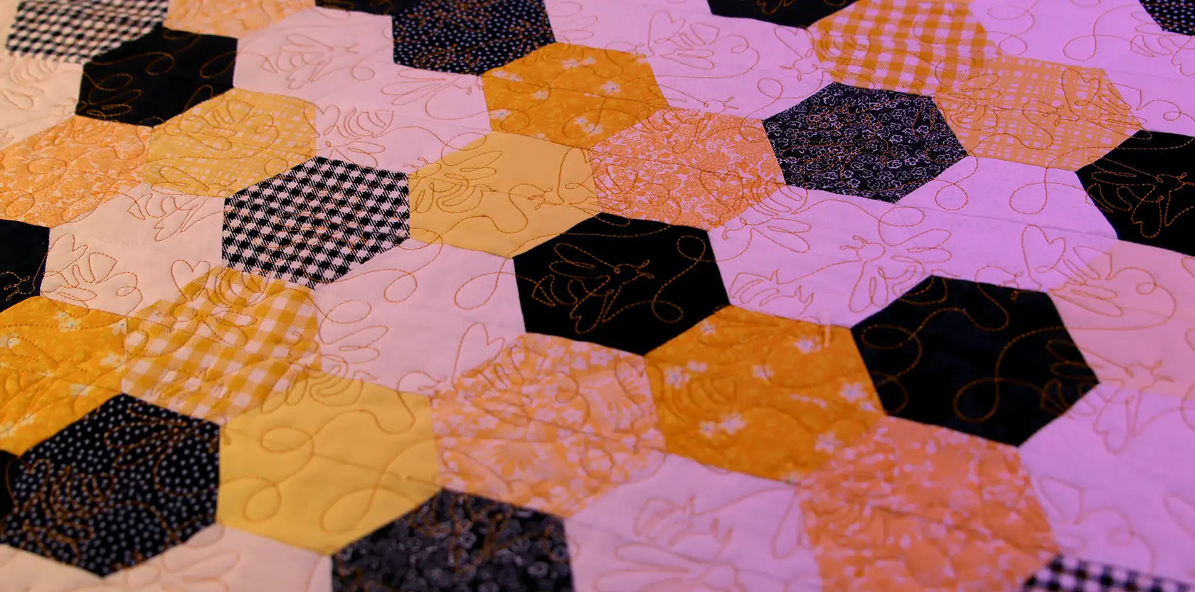 Machine embroidery edge-to-edge bee design on a quilt