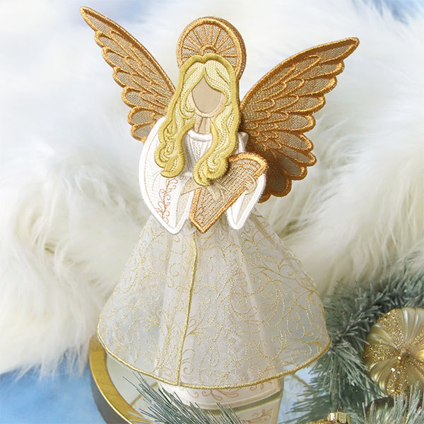 Decorative machine embroidered 3D angel ornament with gold wings and white dress on a soft white background