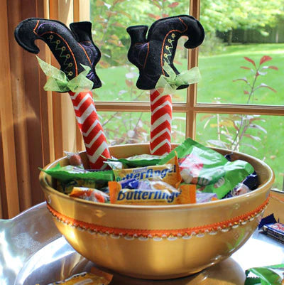 Decorative Halloween candy bowl with witch legs and candy.
